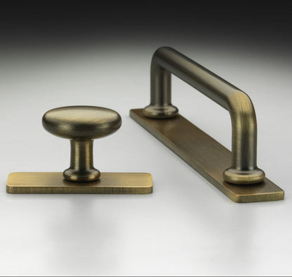 Banbury antique brass cabinet bar handle and knob on backplates