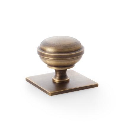 Quantock antique brass cabinet knob on square backplate - 38mm